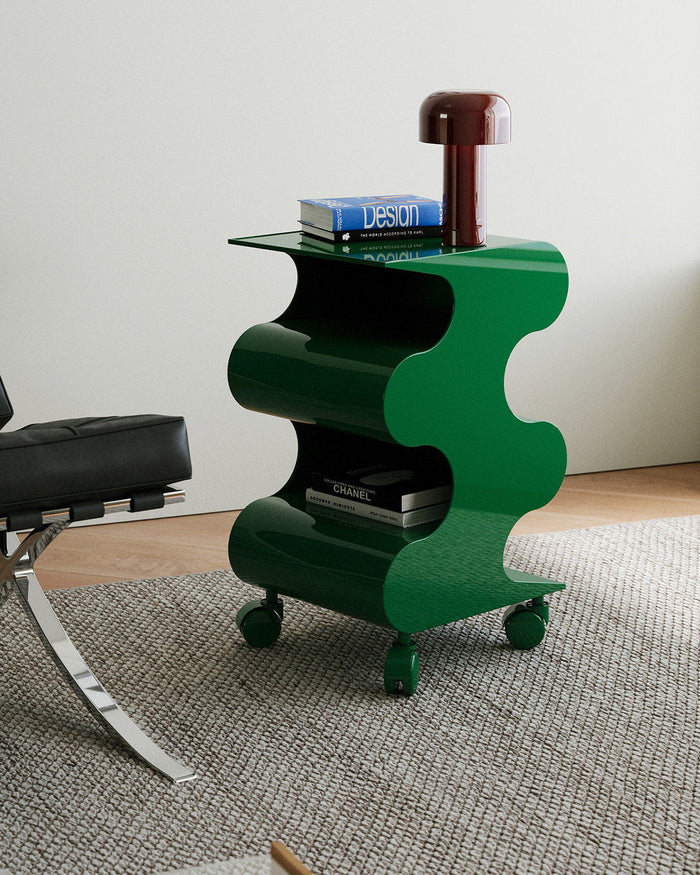 Modern green curved rolling side cart with open shelving and matching green wheels