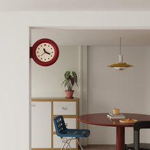 Double-sided round wall clock with bracket-mounted retro design