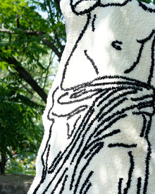 Black and white museum-inspired bedside rug with Leaning Tower of Pisa design