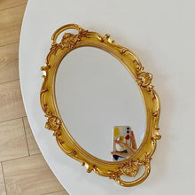 French vintage vanity mirror with ornate gold-tone frame