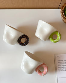 Ceramic mug with a playful donut-shaped handle
