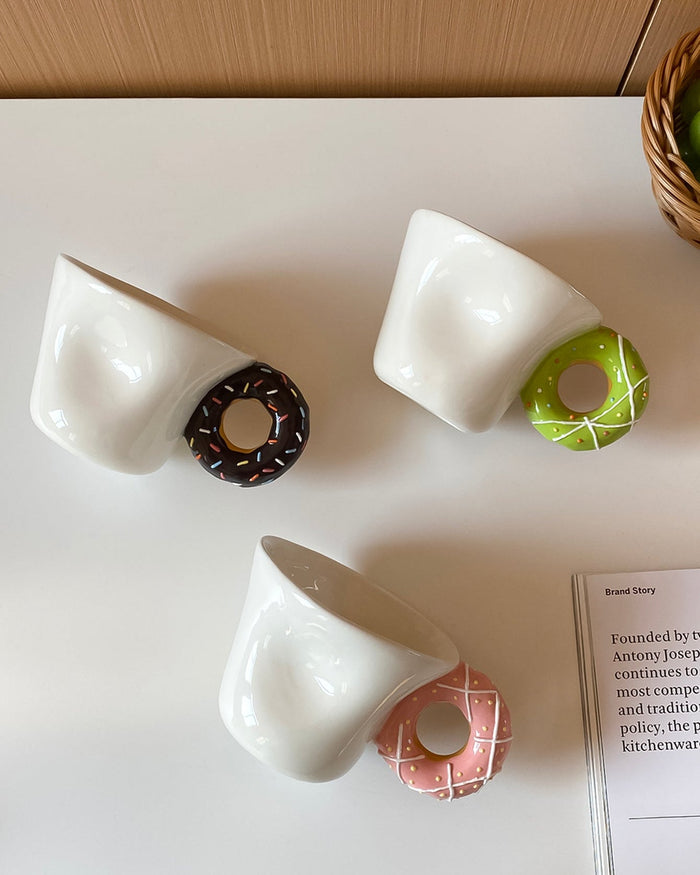 Ceramic mug with a playful donut-shaped handle