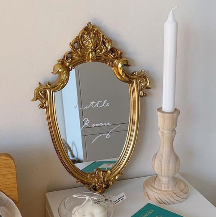 French vintage vanity mirror with ornate gold-tone frame