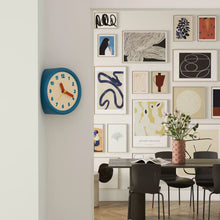 Blue corner wall clock with minimalist dot dial for a 90-degree wall edge