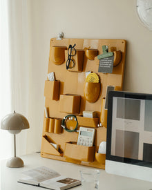 Red wall-mounted pocket organizer panel with compartments and hooks