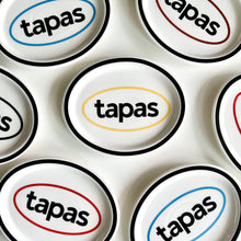 Black oval ceramic tapas plate with graphic text design