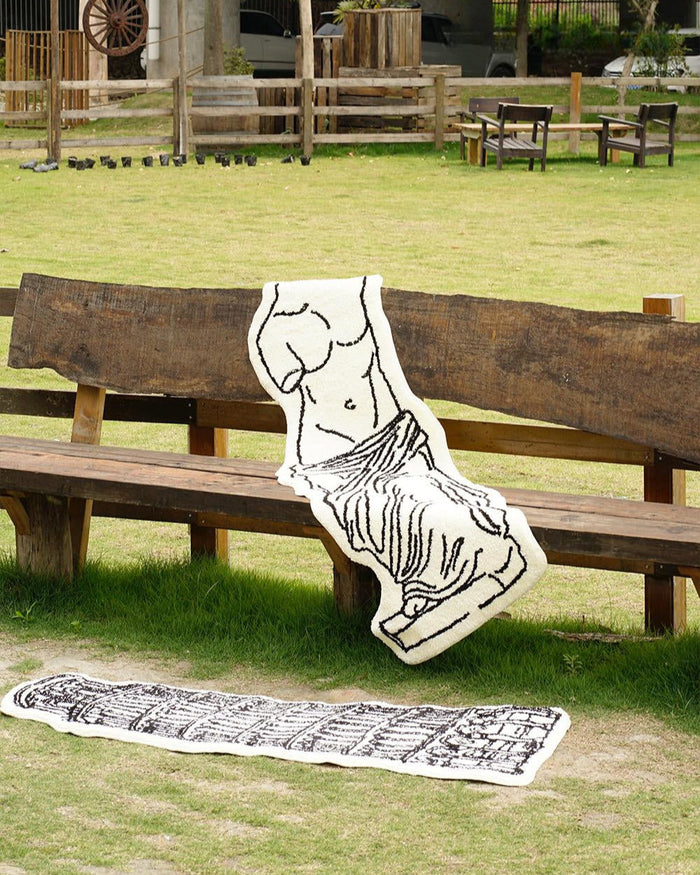 Black and white museum-inspired bedside rug with Leaning Tower of Pisa design