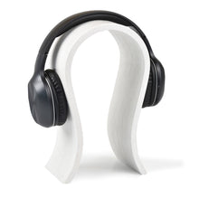 White wooden headphone stand for storing over-ear headphones on a desk