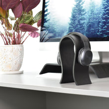 White wooden headphone stand for storing over-ear headphones on a desk