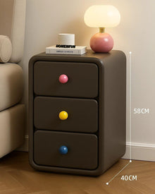 Narrow bedside cabinet with playful drawer knobs and compact storage