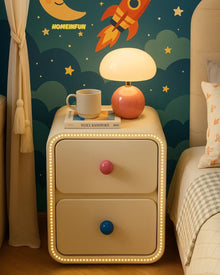 Narrow bedside cabinet with playful drawer knobs and compact storage