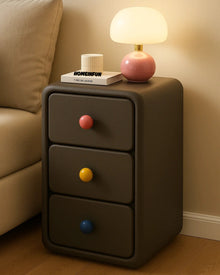 Narrow bedside cabinet with playful drawer knobs and compact storage
