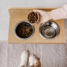 Wall-mounted oak wooden dog feeder with two stainless steel bowls