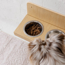 Wall-mounted oak wooden dog feeder with two stainless steel bowls
