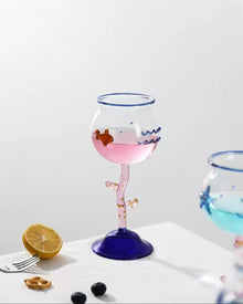 Ocean-inspired wine glass with fish motif and coral-style stem