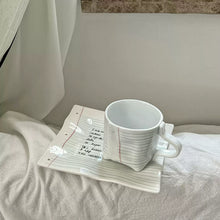 Notebook-inspired ceramic coffee cup with matching tray