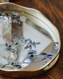Peacock mirror decorative tray with floral motif and gold-toned wavy frame