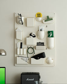 Red wall-mounted pocket organizer panel with compartments and hooks