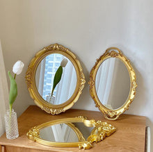 French vintage vanity mirror with ornate gold-tone frame