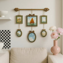 Vintage multi-frame hanging wall art with green and gold frames and landscape artwork