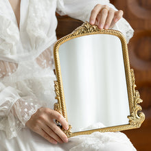 Gold carved vanity mirror with vintage French-inspired frame