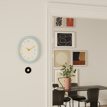 Oval light blue wall clock with pendulum for home decor