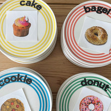 Striped ceramic dessert plate with colourful concentric lines and playful cake typography