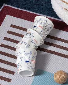 Set of four ceramic coffee cups with cat and dog illustrations