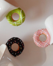 Ceramic mug with a playful donut-shaped handle