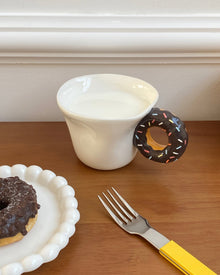 Ceramic mug with a playful donut-shaped handle