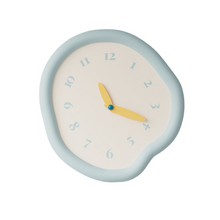 White asymmetrical drip wall clock with a playful melting-inspired shape