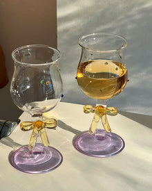 Handmade ribbon charm glass goblet with amber stem, lilac base, and colorful bead accents