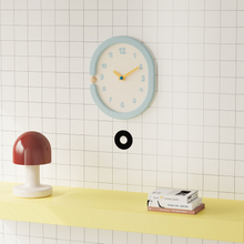 Oval light blue wall clock with pendulum for home decor