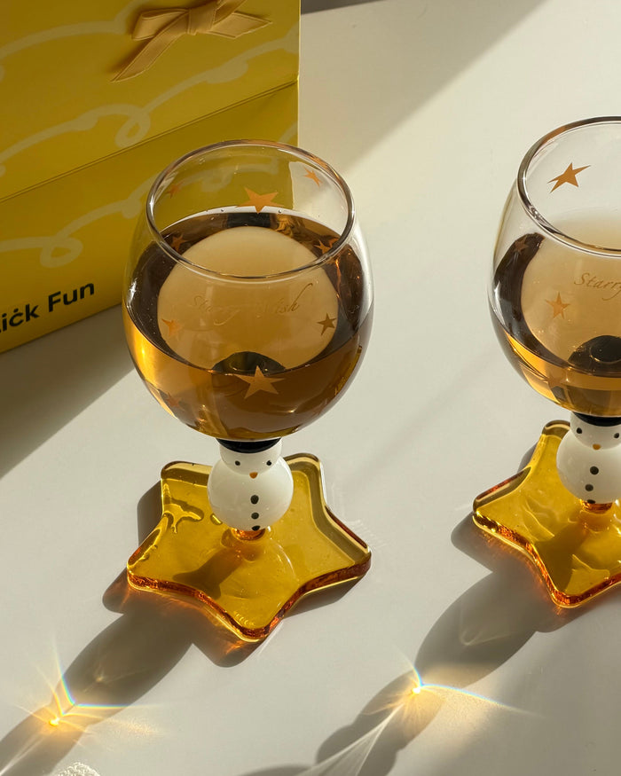 Snowman wine glass with amber star-shaped foot and golden star details