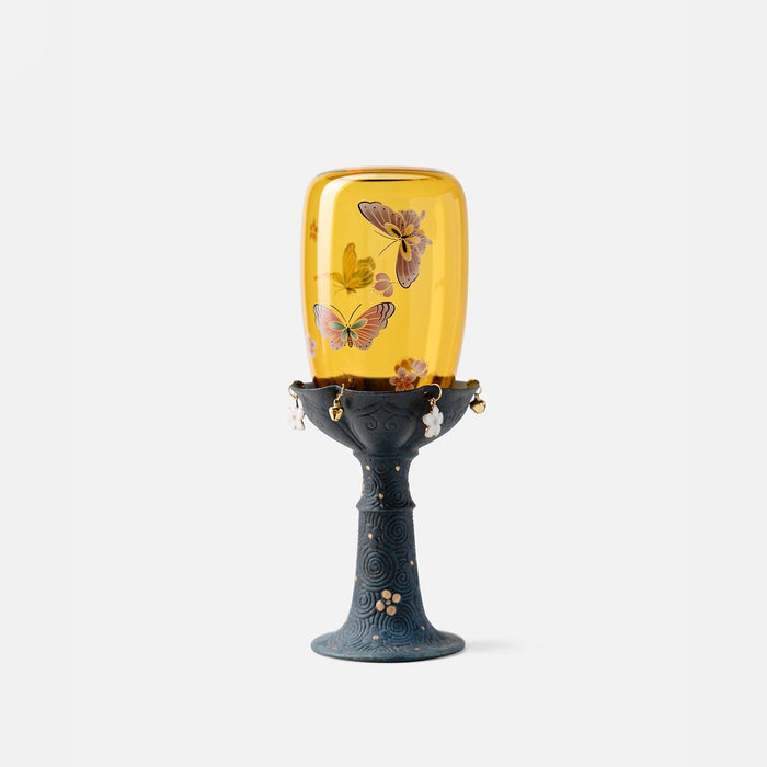 Chinese-inspired glass and ceramic candle holder with decorative nature motifs