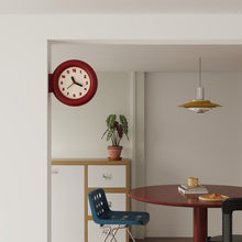 Double-sided round wall clock with bracket-mounted retro design