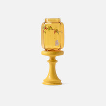 Chinese-inspired glass and ceramic candle holder with decorative nature motifs