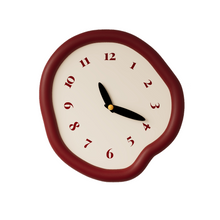 White asymmetrical drip wall clock with a playful melting-inspired shape
