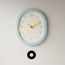 Oval light blue wall clock with pendulum for home decor