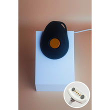 White standing Gondosóra charging dock for original magnetic charging cable