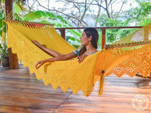 Yellow Estelí Deluxe L-bar cotton hammock with wooden spreader bars and decorative fringe
