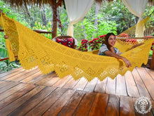 Yellow Estelí Deluxe L-bar cotton hammock with wooden spreader bars and decorative fringe