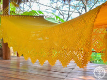 Yellow Estelí Deluxe L-bar cotton hammock with wooden spreader bars and decorative fringe