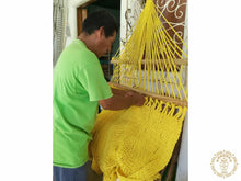 Yellow Estelí Deluxe L-bar cotton hammock with wooden spreader bars and decorative fringe