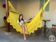 Yellow Estelí Deluxe L-bar cotton hammock with wooden spreader bars and decorative fringe