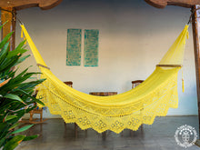 Yellow Estelí Deluxe L-bar cotton hammock with wooden spreader bars and decorative fringe
