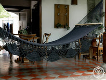 Black cotton L-bar hammock with wooden spreader bars