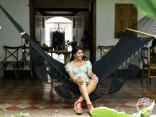 Black cotton L-bar hammock with wooden spreader bars