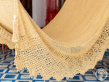 Handwoven León Deluxe L-bar cotton hammock with wooden spreader bars and decorative fringe