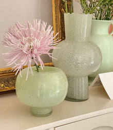 Green round glass vase for flowers and home decor